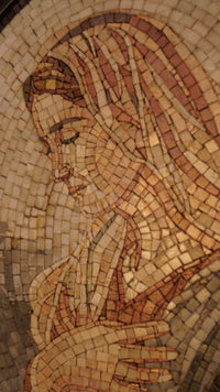 Intricate mosaic artwork depicting a serene figure with soft earth tones and textured tiles creating a captivating visual depth