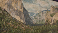 Intricate mosaic artwork depicting a mountainous landscape with textured stone tiles in earthy tones and subtle shading.