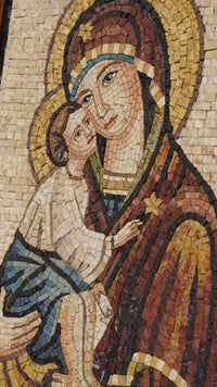 Intricate mosaic artwork depicting a mother and child, featuring rich earth tones and detailed facial expressions.