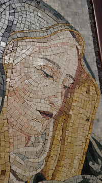 Intricate mosaic artwork depicting a serene figure with soft hues and detailed textures, showcasing craftsmanship in stone.