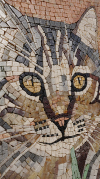 Intricate mosaic artwork featuring a cat's face with vibrant tiles in shades of brown, gray, and yellow eyes.