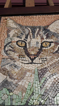 Intricate mosaic cat portrait crafted from colorful tiles — featuring detailed eyes and a naturalistic expression