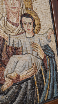 Intricate mosaic artwork depicting a mother holding a child, featuring earthy tones and detailed textures.