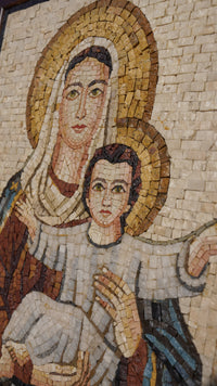 Intricate mosaic artwork depicting a mother and child in warm earthy tones — detailed craftsmanship with textured tiles.