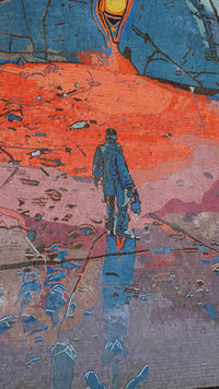 A vibrant mural featuring a figure walking on a textured surface, surrounded by bold reds and purples — a striking urban artwork.