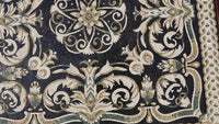 Intricate mosaic tile design featuring a blend of white, green, and gold patterns on a dark background — showcasing artisanal craftsmanship.