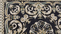Intricate mosaic tile design featuring ornate floral patterns in black, cream, and green hues — a stunning artistic craftsmanship
