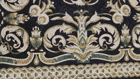 Intricate mosaic tile design featuring a floral pattern in black, white, and earthy tones — showcasing exquisite craftsmanship.
