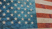 Vibrant mosaic of the American flag with blue and red tiles featuring white stars and stripes, showcasing intricate craftsmanship.