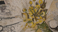Intricate mosaic artwork featuring vibrant yellow floral patterns against a textured background — a stunning display of craftsmanship.