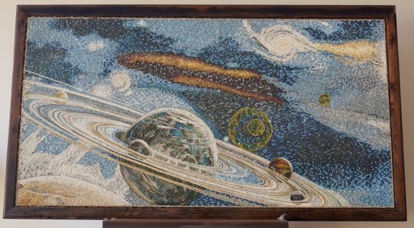 Vivid mosaic art depicting planets and rings in a cosmic scene — intricate details on a textured canvas backdrop