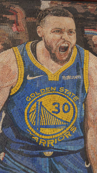 Vibrant mosaic artwork depicting a passionate basketball player in a blue Golden State Warriors jersey with yellow accents