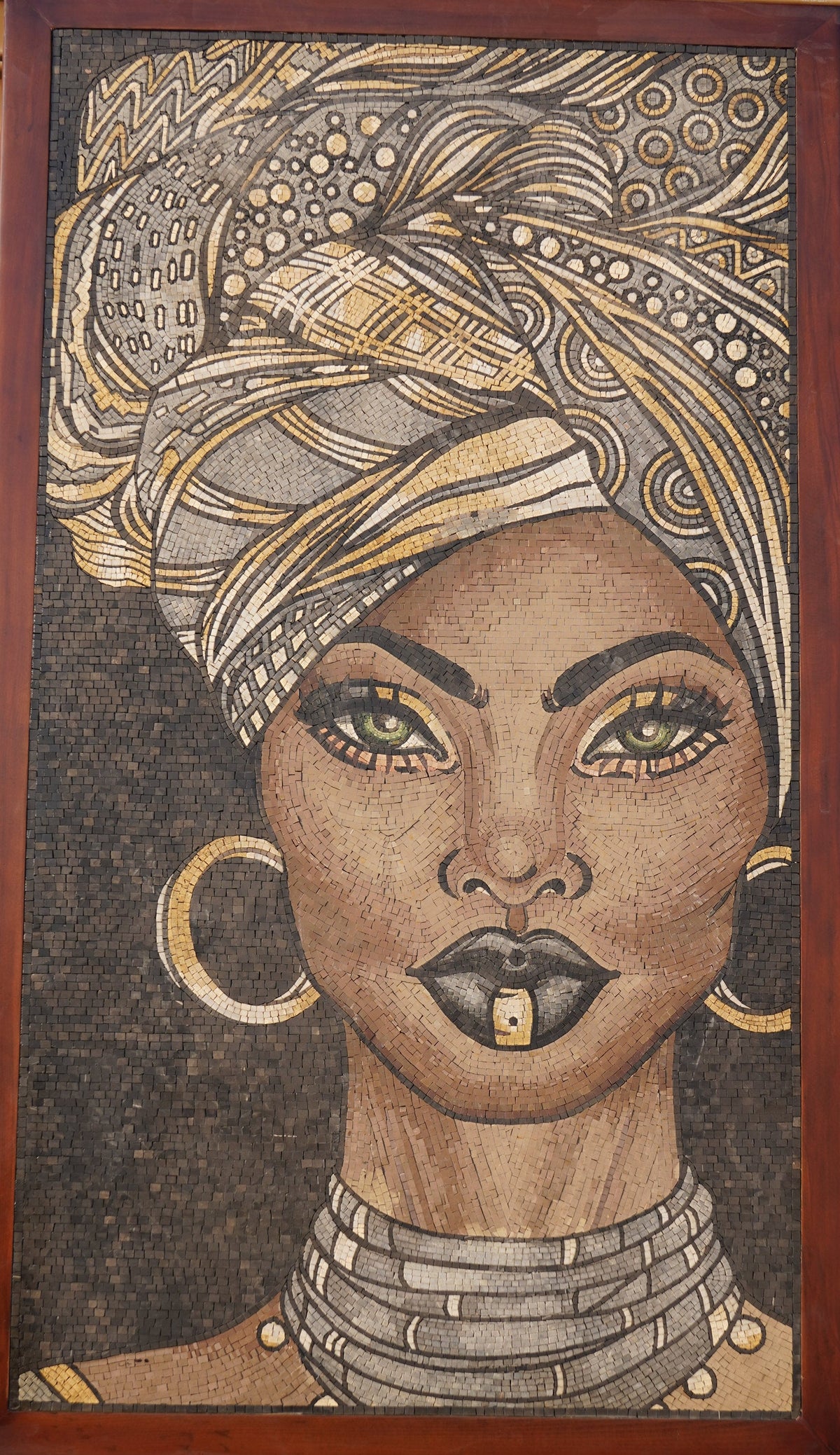 Intricate mosaic art featuring a woman with striking green eyes and a patterned headwrap — showcasing detailed craftsmanship and vibrant colors.