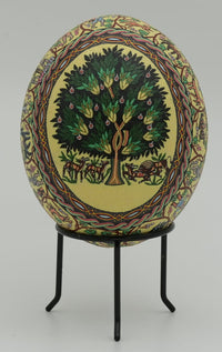 Intricately designed decorative egg featuring a vibrant tree motif surrounded by colorful patterns on a stand