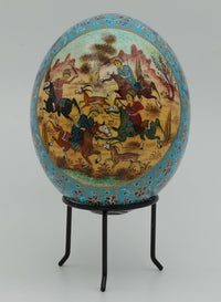 Intricately painted decorative egg featuring a vibrant scene of horsemen in a pastoral landscape, set on a sleek black stand