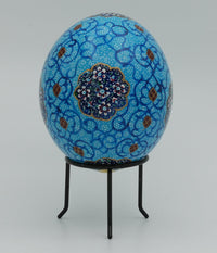 Intricately designed decorative egg featuring vibrant blue patterns and floral motifs — a unique piece of artistic craftsmanship