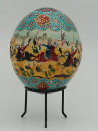 Intricately painted decorative egg featuring vibrant scenes of horsemen in traditional attire against a colorful background.