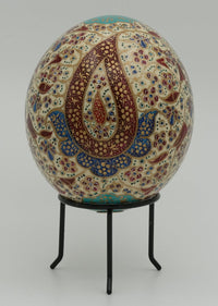 Intricately designed decorative egg with vibrant patterns in red and blue — a stunning piece of handcrafted art.