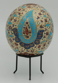 Intricately designed decorative egg featuring vibrant blue and red patterns on a cream background — a unique artistic piece.