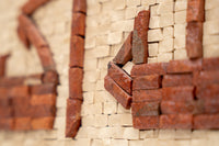 Intricate mosaic art featuring textured clay tiles in earthy tones — a unique blend of rustic and modern design.