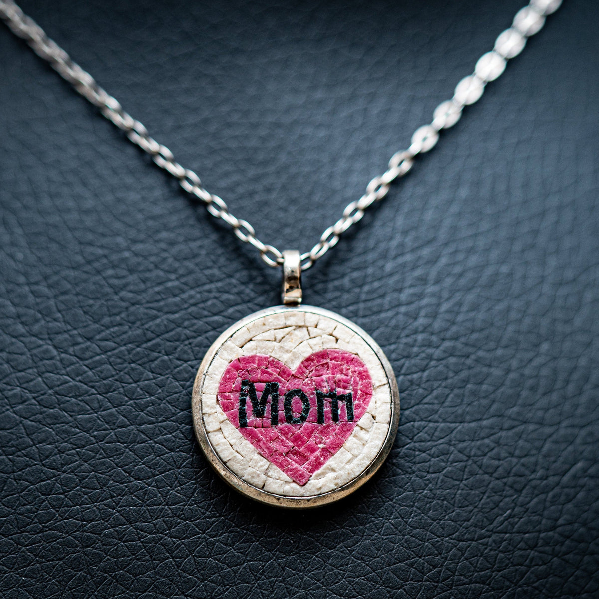 Necklace with a heart-shaped pendant on a textured dark surface