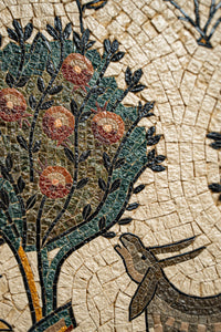 Intricate mosaic art featuring a tree adorned with red fruits and a stylized animal — rich textures and vibrant colors create depth.
