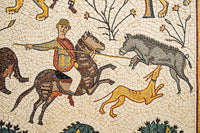 Intricate mosaic artwork depicting a mounted hunter capturing a wild boar, surrounded by stylized animals and foliage.