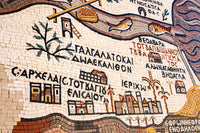 Intricate mosaic artwork featuring vibrant tiles with detailed scenes of fish and palm trees, showcasing ancient craftsmanship.