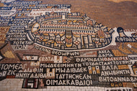 Intricate mosaic artwork depicting a historic cityscape with detailed stone patterns and vibrant colors, showcasing ancient architecture.