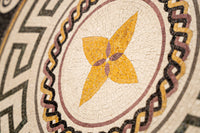 Intricate mosaic design featuring a vibrant yellow flower surrounded by geometric patterns — a stunning blend of artistry and craftsmanship.