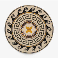 Intricate round mosaic table top featuring a geometric pattern in earthy tones with a central floral design and black accents
