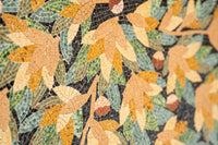 Intricate mosaic artwork featuring vibrant autumn leaves in shades of green, yellow, and orange with textured details.