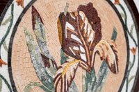 Intricate mosaic wall art featuring a blooming iris in earthy tones — handcrafted tiles create a textured floral design