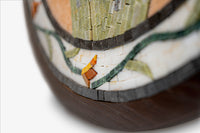 Intricate mosaic vase featuring earthy tones and detailed floral designs — crafted from ceramic with a polished finish