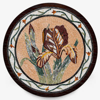 Intricate mosaic art featuring a brown iris flower surrounded by green leaves and decorative borders on a round wooden base