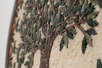 Intricate mosaic wall art featuring a tree design with green and brown stone pieces — adding a natural texture to any space
