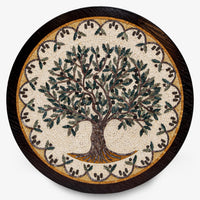 Intricate mosaic wall art featuring a tree design with green leaves on a circular wooden base — crafted with detailed artistry.