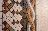 Intricate mosaic tile design featuring earthy tones and geometric patterns — a blend of natural stone and artistic craftsmanship.