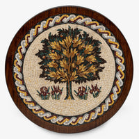 Intricate mosaic wall art featuring a vibrant tree design with colorful leaves and floral accents on a wooden frame