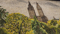 Intricate mosaic artwork depicting a city skyline with vibrant yellow trees in the foreground — showcasing detailed craftsmanship.