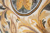 Intricate mosaic wall art featuring golden and black tiles with a textured finish that enhances its ornate design