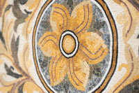 Intricate mosaic design featuring a vibrant yellow flower surrounded by detailed patterns and rich textures