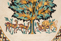 Intricate mosaic artwork featuring a tree and animals in warm hues — a vibrant depiction of nature's harmony.