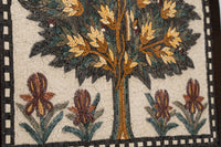 Intricate mosaic artwork featuring a vibrant tree design with golden leaves and colorful floral accents on a textured background