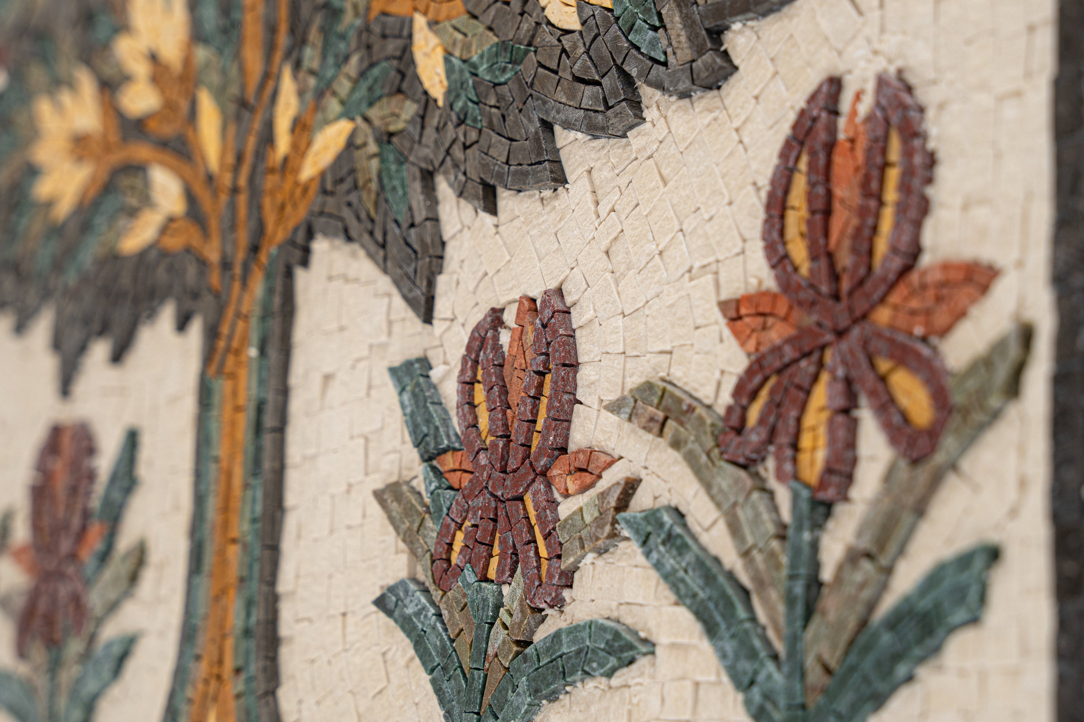 Intricate mosaic wall art featuring vibrant flowers and a tree design — handcrafted with colorful ceramic tiles.