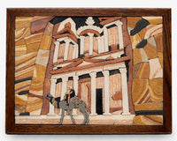 Intricate mosaic artwork depicting a camel and rider in front of ancient architecture — crafted with natural stone textures.