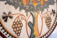 Intricate mosaic artwork featuring floral and fruit designs in earthy tones — a blend of natural textures and craftsmanship.
