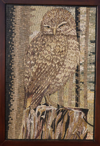 Intricate mosaic artwork depicting a brown owl perched on a tree stump — crafted from various natural wood tones.