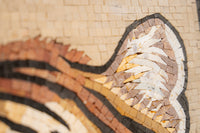 Intricate mosaic artwork featuring a tiger's ear with textured tiles in warm earth tones and subtle shading details.