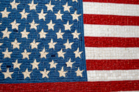 Detailed American flag mosaic with blue and white star accents—crafted from textured tiles for a striking visual effect